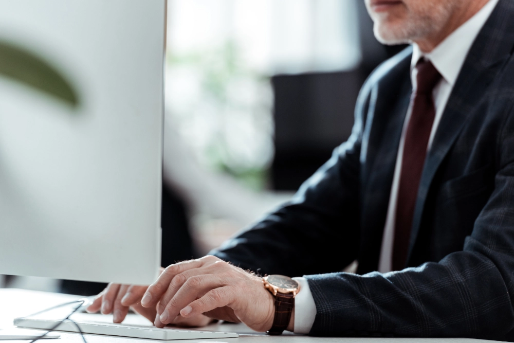 cropped-view-of-businessman-typing-on-computer