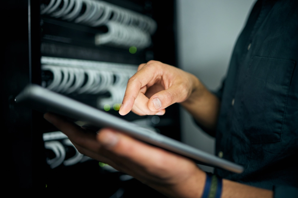 hands-tablet-and-typing-in-server-room